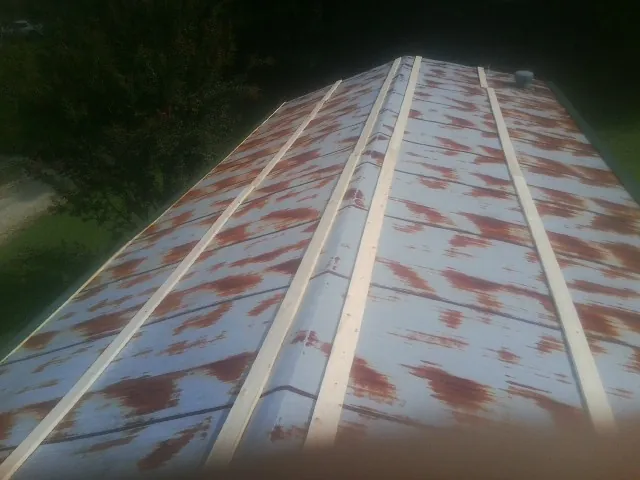 Rusted metal roof panels with new wood purlins before replacement — Storm Damage Roof Repair in North Augusta by Roofing Brothers