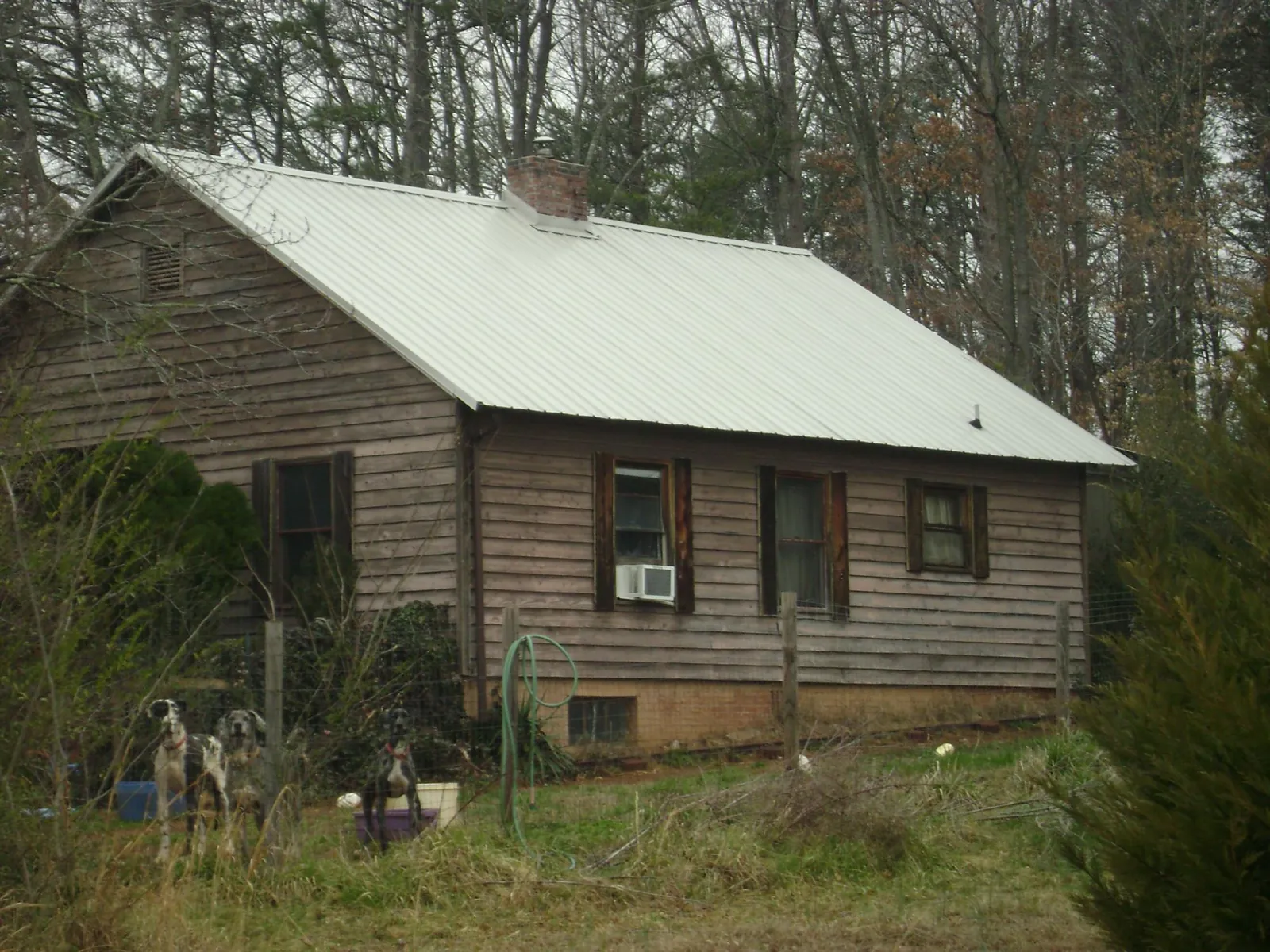 White metal roof on an old wood sided farmhouse, from a Metal Roof Installation job in North Augusta